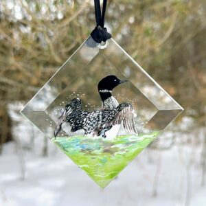 Hand-painted loon glass suncatcher hanging in sunny window