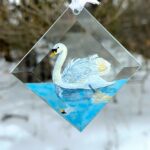 Hand-painted Swan suncatcher, an elegant glass art piece hanging in a window. Perfect for bird lovers and nature-inspired home decor.