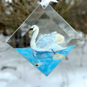 Hand-painted Swan suncatcher, an elegant glass art piece hanging in a window. Perfect for bird lovers and nature-inspired home decor.